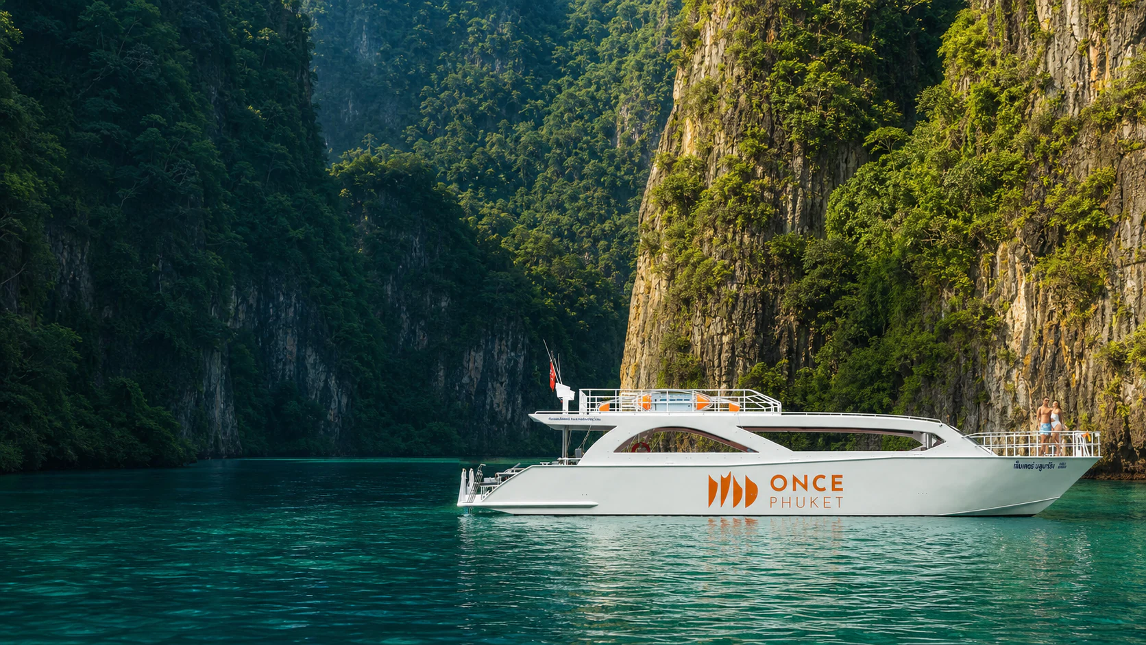 Катамаран ONCE PHUKET на бирюзовой воде среди зелёных скал